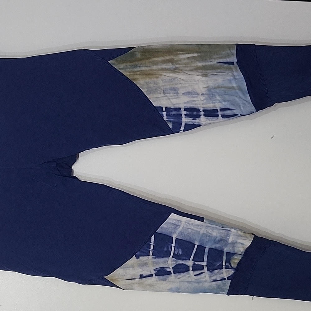 Blue and tie dye workout leggings with sheer material at ankles